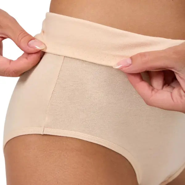 Close do tecido elástico da cueca de algodão bege cintura média, destacando o conforto do cós