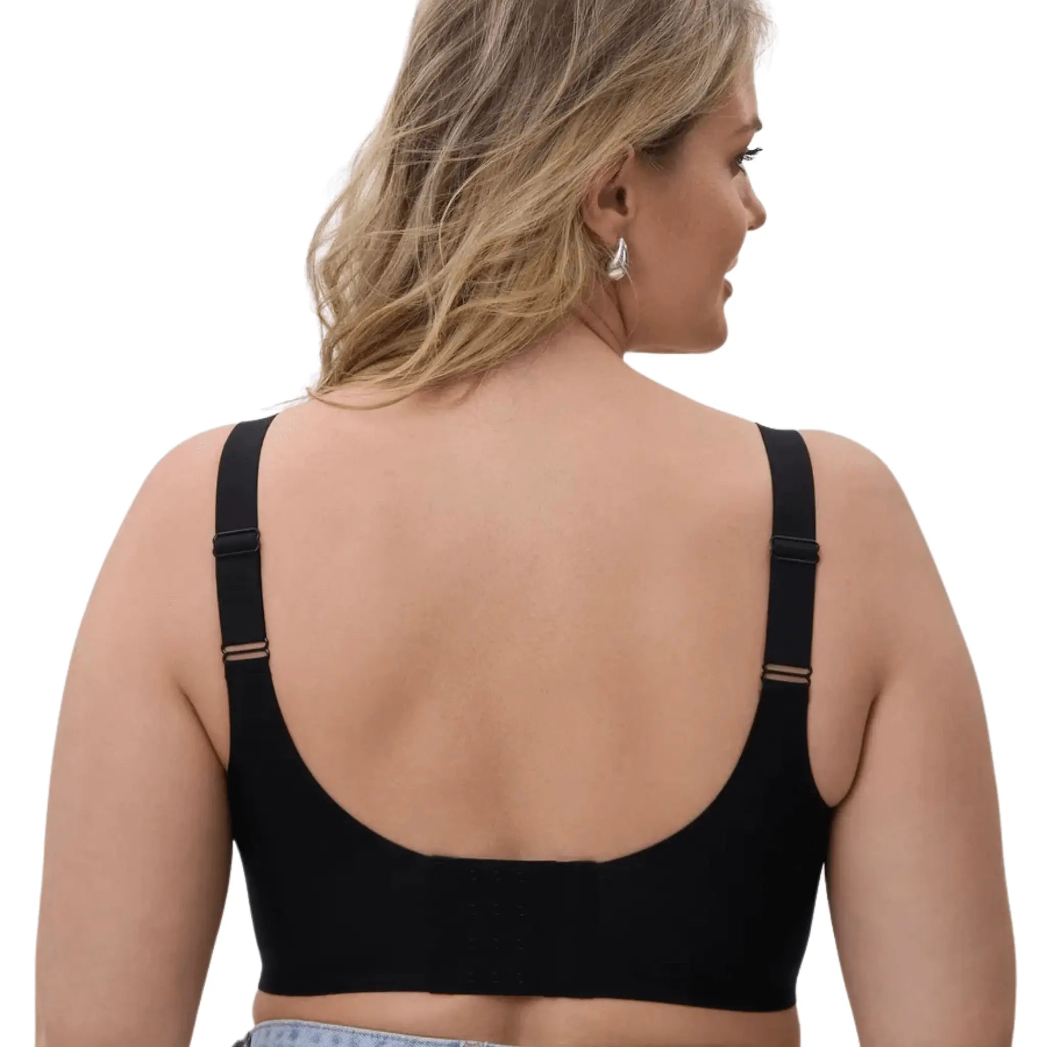 Vista traseira da modelo, usando soutien preto redutor com fecho de colchetes e alças ajustáveis.